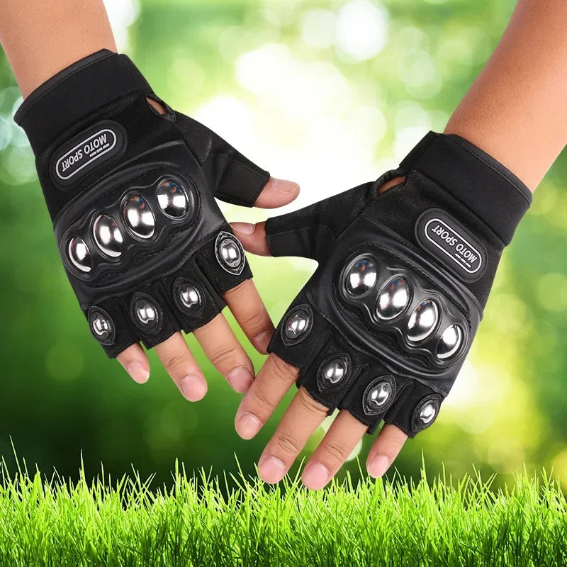 Black gloves with metallic accents held in front of a blurred green background