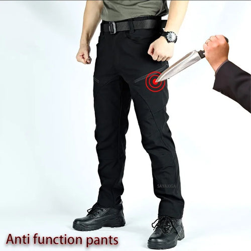 Black tactical pants with a red target graphic overlay on the thigh, shown on a model with a knife pointed at the leg. Cut-Resistant Tactical Trousers
