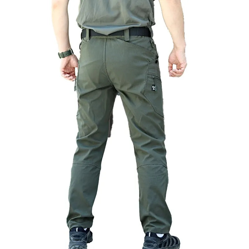 A person shown from the back wearing olive Cut-Resistant Tactical Trousers.