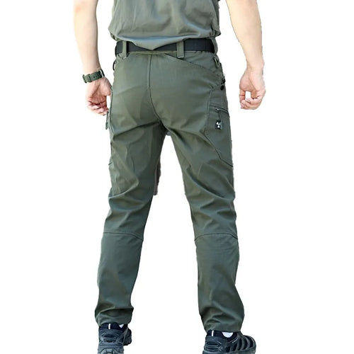 A person shown from the back wearing olive Cut-Resistant Tactical Trousers.